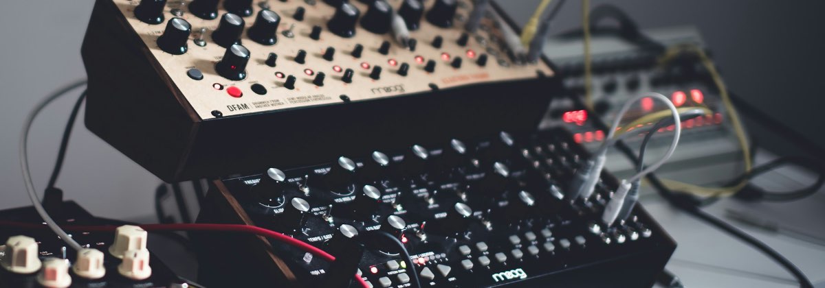 Close-up of knobs and patch cables on a modular analog synthesizer