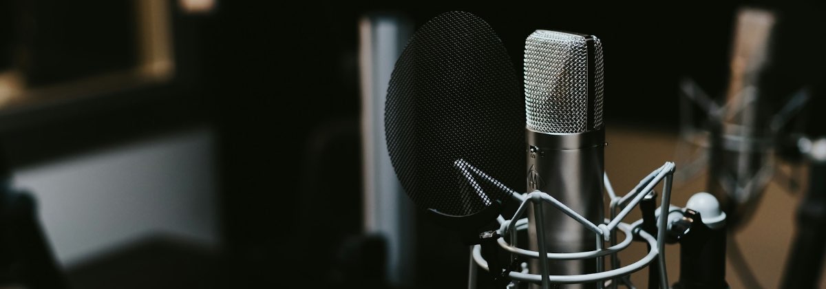 Podcast microphone setup in a studio for audio ducking