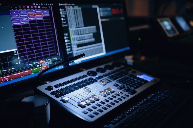 Audio engineer configuring noise gate parameters on a studio mixer